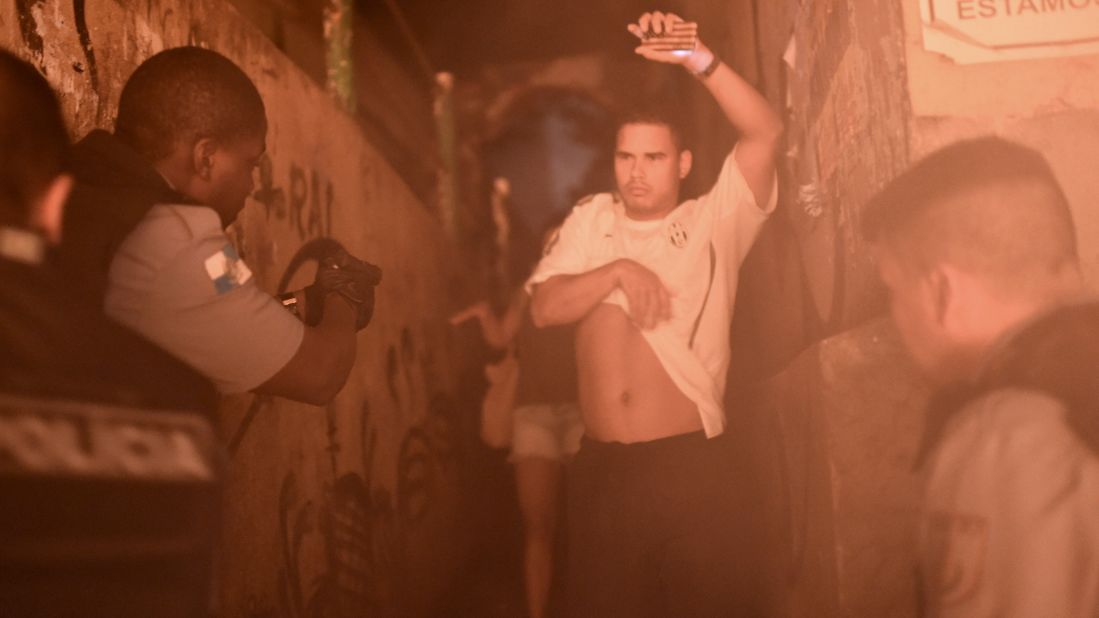 Brazilian police detain a man during a violent protest in the Pavao-Pavaozinho community near Copacabana Beach in Rio de Janeiro on Tuesday, April 22. Residents took to the streets after a young male dancer was found dead, state-run Agencia Brasil said. The residents told Brazilian media they blame the police for the death. 