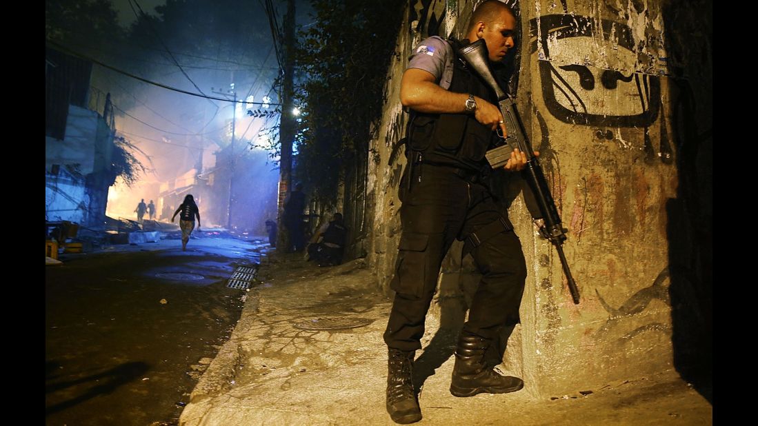 A police officer patrols a street just blocks from Copacabana Beach.