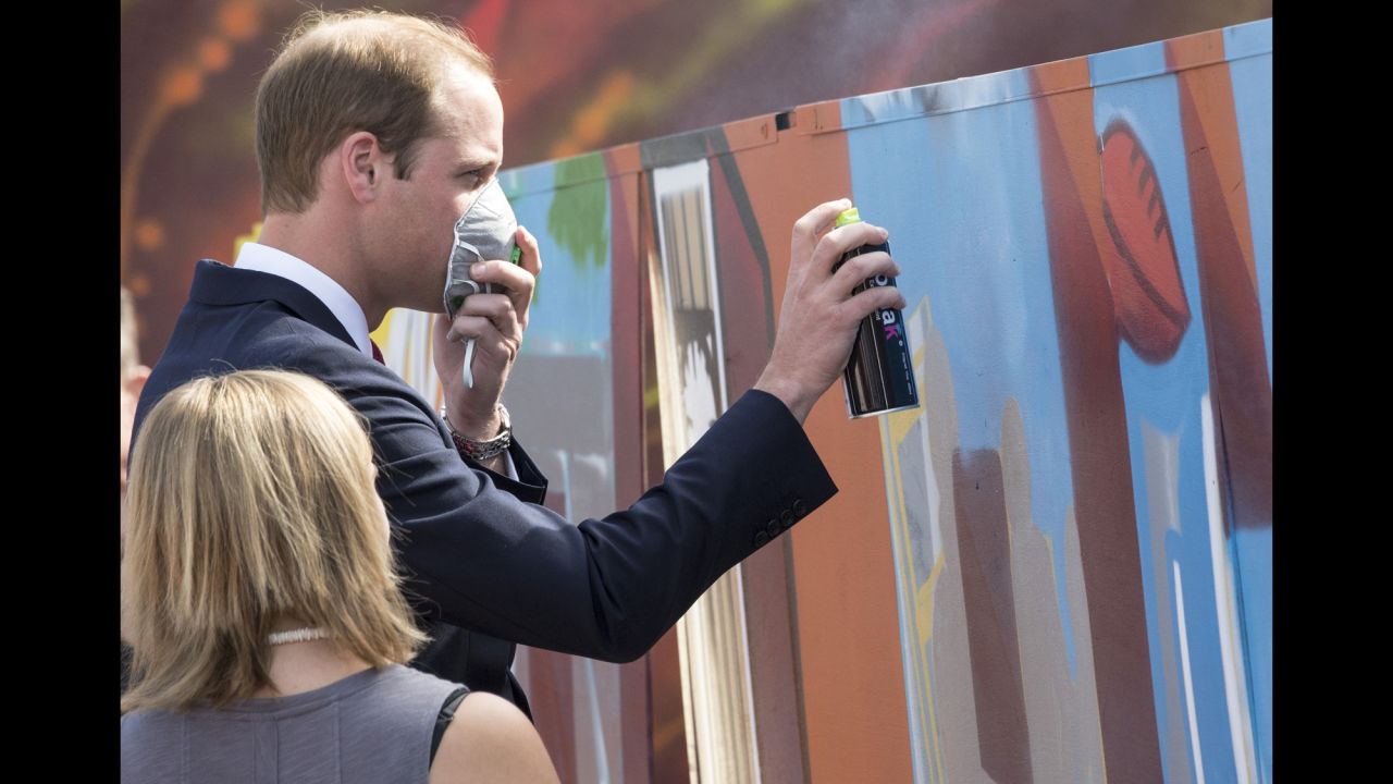 Prince William uses a spray canister during a visit to a skate park on April 23.  