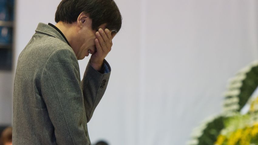 A man reacts as he visits a group memorial altar for the victims from the sunken South Korean ferry 'Sewol' at the Ansan Olympic memorial hall on April 23, 2014.