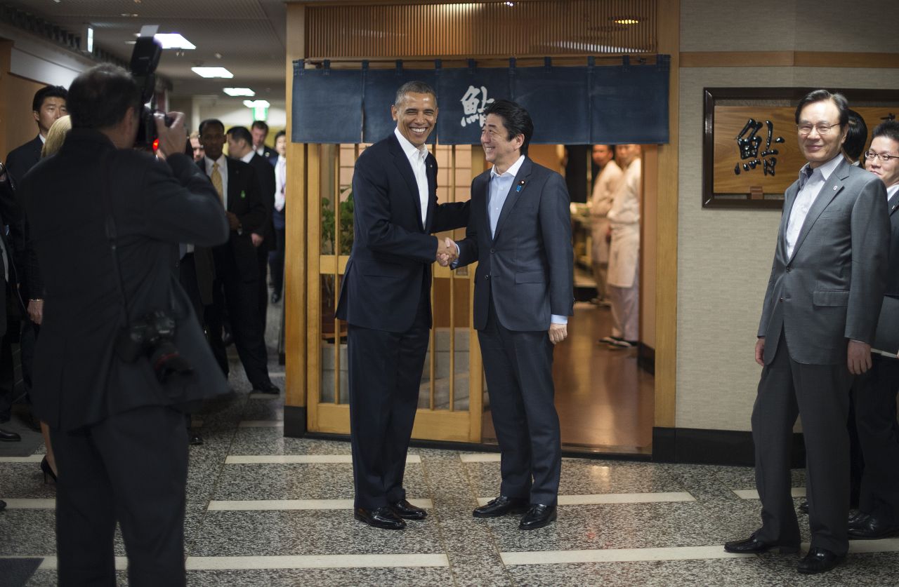 Abe greets Obama before dinner.