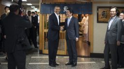 President Obama, left, shakes hands with Japanese Prime Minister Shinzo Abe before a private dinner at Sukiyabashi Jiro restaurant in Tokyo on April 23.  Obama landed in Tokyo on April 23 to launch an Asian tour dedicated to reinvigorating his policy of "rebalancing" US foreign policy towards a dynamic Asia. Sukiyabashi Jiro's less-than-plush surroundings notwithstanding, it is the proud possessor of three Michelin stars, and people flock to pay a minimum $300 for 20 pieces of sushi chosen by the 88-year-old patron, Jiro Ono.