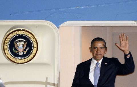 Obama steps from Air Force One after landing in Tokyo on April 23. 