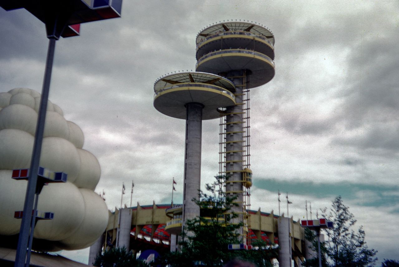 The New York State Pavilion, with <a href="http://ireport.cnn.com/docs/DOC-1123631">two observation towers</a> and the Tent of Tomorrow, still stands. The white bubbles to the left belonged to the Brass Rail lunch bar.