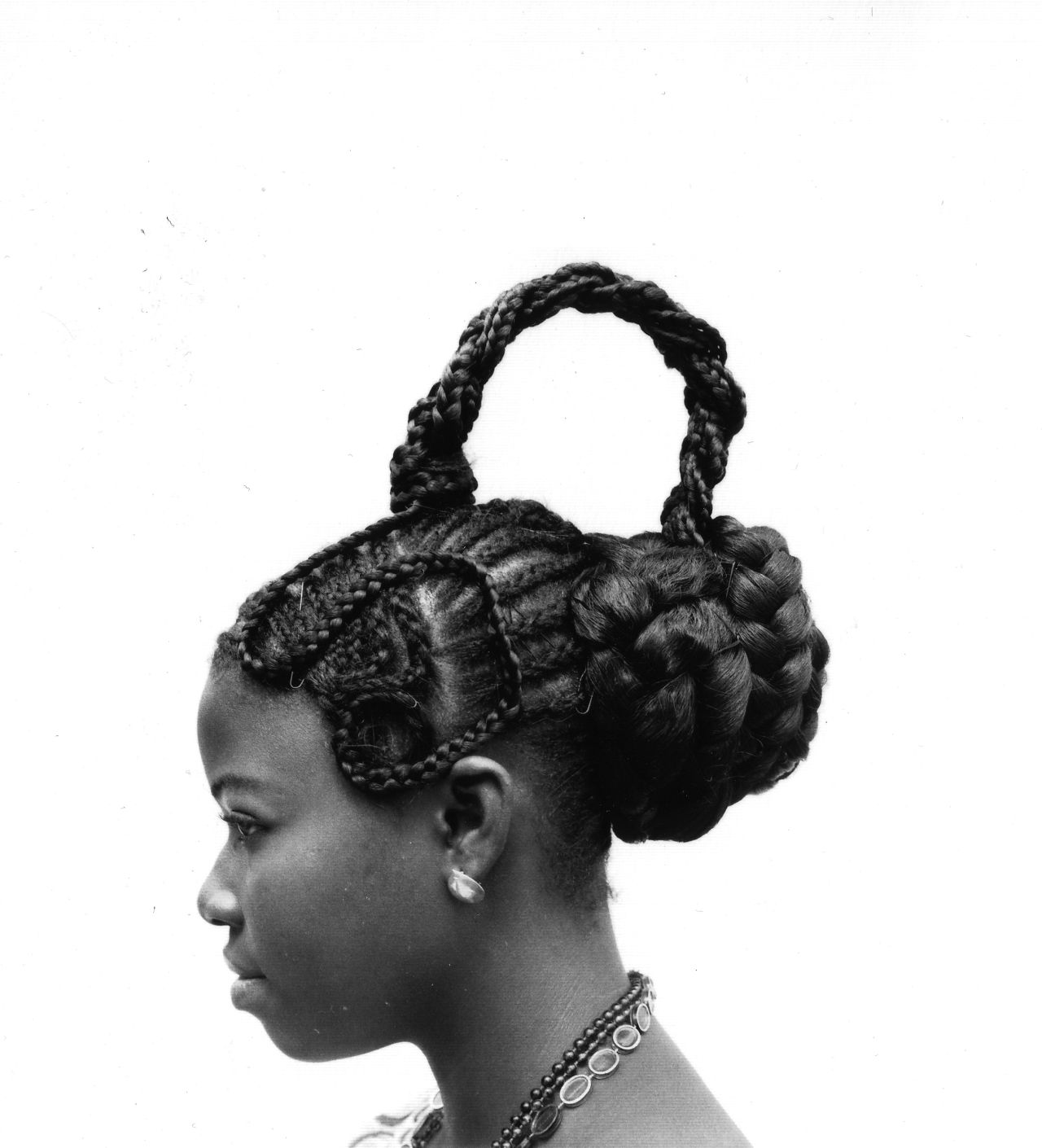 Abebe, 1975. These images of Nigerian hairstyles were taken by world-renowned photographer J. D. 'Okhai Ojeikere. He travelled the streets of 1960s Lagos with his Brownie D camera, capturing the intricately designed hairstyles of his fellow country people. 