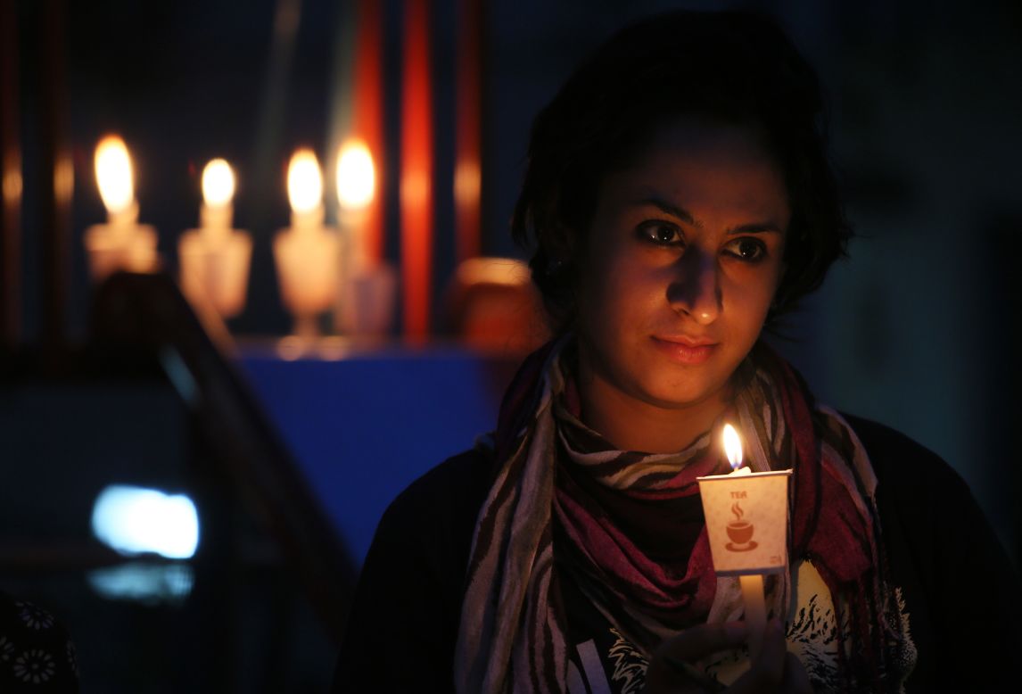 APRIL 23 - NEW DELHI, INDIA: A girl holds a candle during a Greenpeace awareness campaign to save Mahan forest in the Indian state of Madhya Pradesh on <a href="http://www.cnn.com/2014/04/21/opinion/sanderson-earth-day-cars/">Earth Day,</a> April 22, 2014. Events were held worldwide to help preserve the environment, including demonstrations, planting trees and using minimal electrical power. 