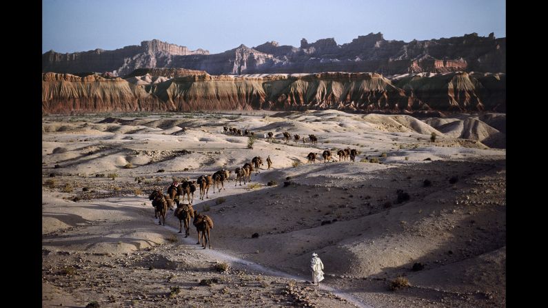 A camel caravan works its way across the rocky terrain in southern Afghanistan, 1980. 