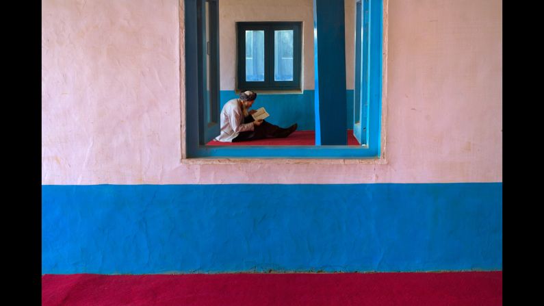 A man reads at a mosque in Bamiyan, 2006.