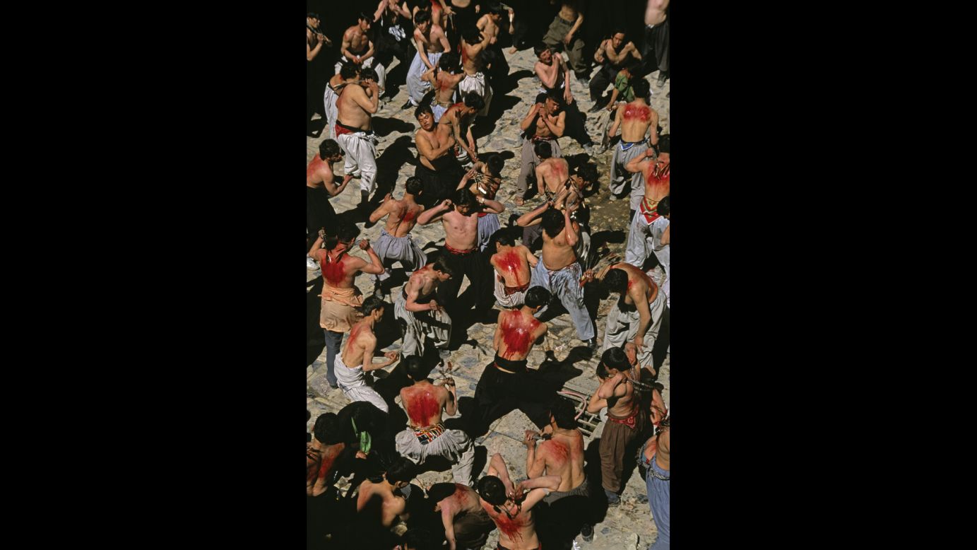 Shiite Muslims flagellate themselves during Ashura in Kabul, 2002.