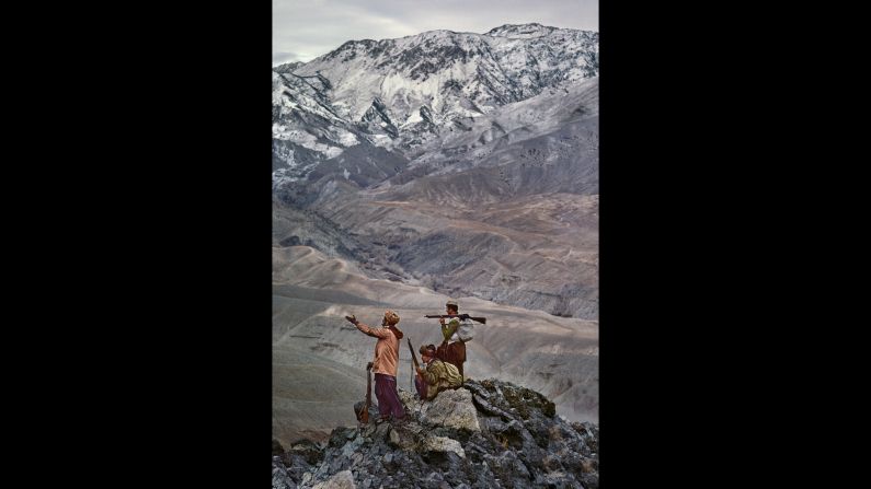 Mujahedeen stand atop a mountain in the Hindu Kush, 1984. 