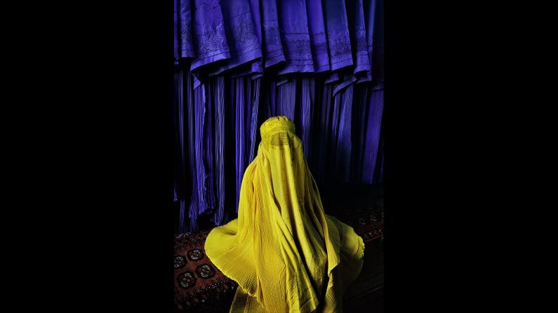 An Afghan woman wears a canary burqa in Kabul, 2002. 