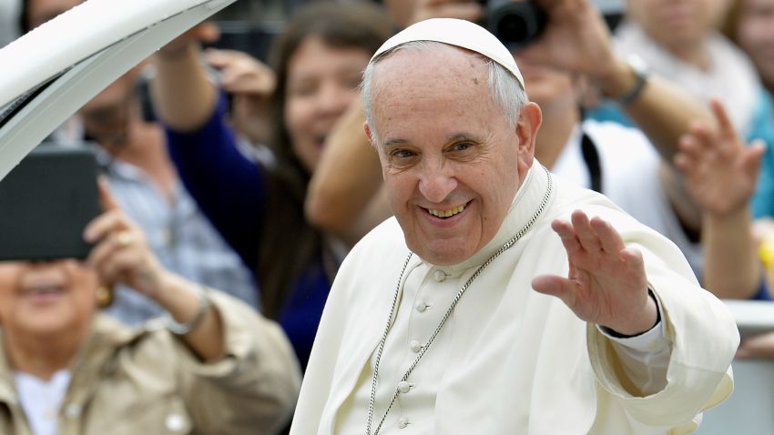 Pope Francis waves to pilgrims upon his arrival in St Peter's square at the Vatican, on April 23, 2014.