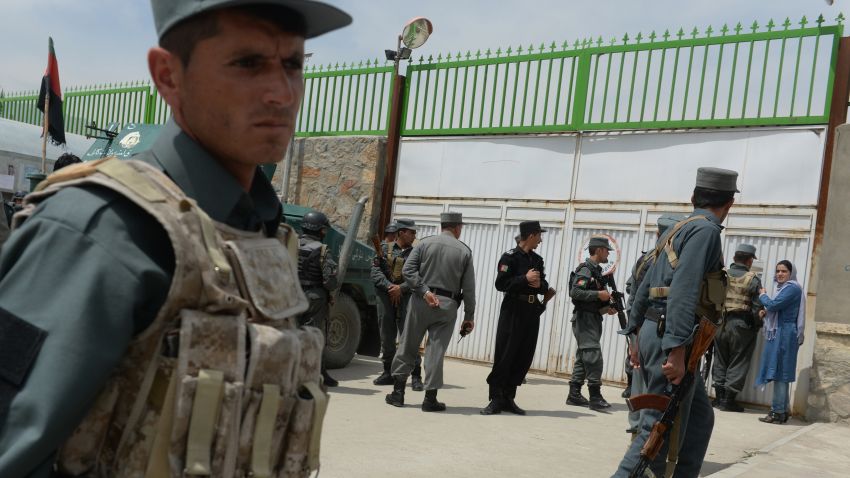 Afghan policemen stand guard at the gate of the Cure hospital in Kabul on April 24, 2014.