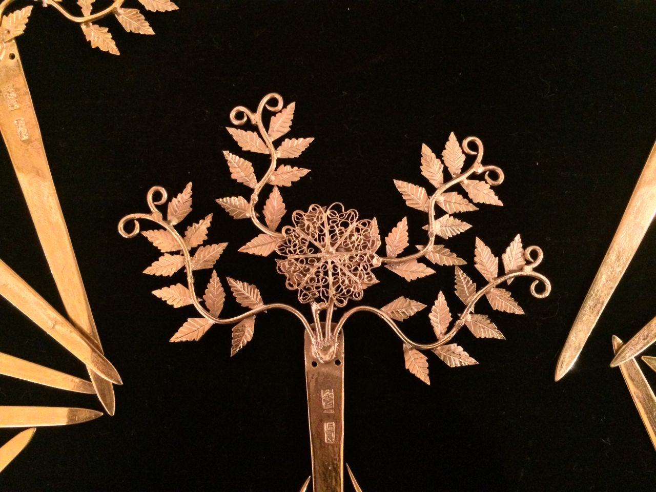 Wealthy merchants favored a sophisticated style, and appreciated the mastery of craftsmanship, such as this filigree of ferns, as much as the value of gems and gold on display.