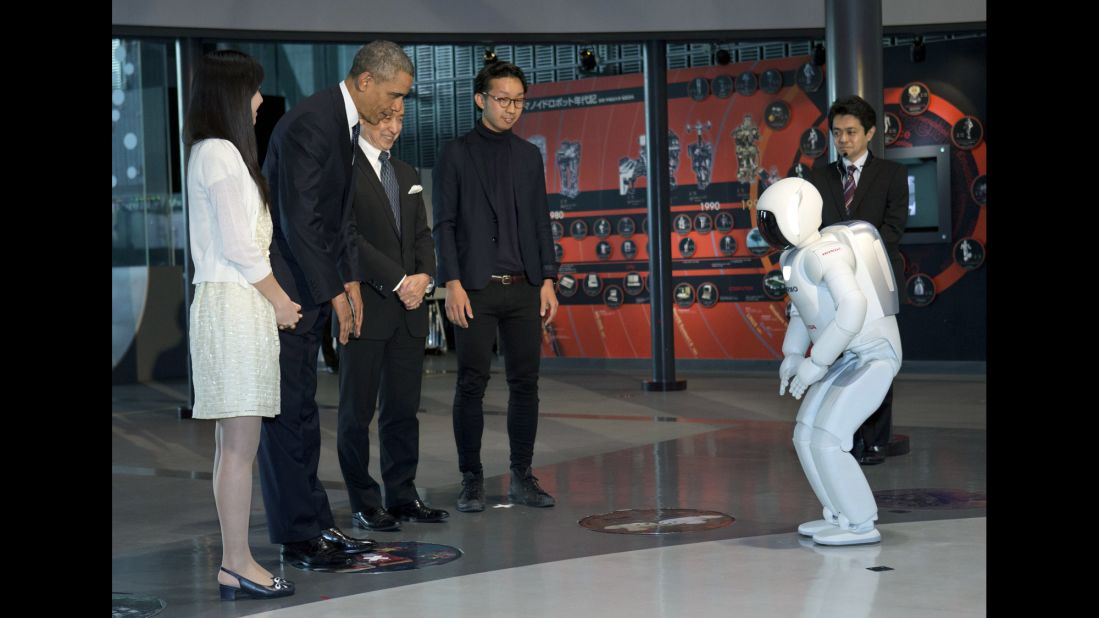 Obama and Honda Motor's humanoid robot ASIMO, an acronym for Advanced Step in Innovative Mobility, bow to each other during a youth science event at the National Museum of Emerging Science and Innovation in Tokyo on Thursday, April 24.  