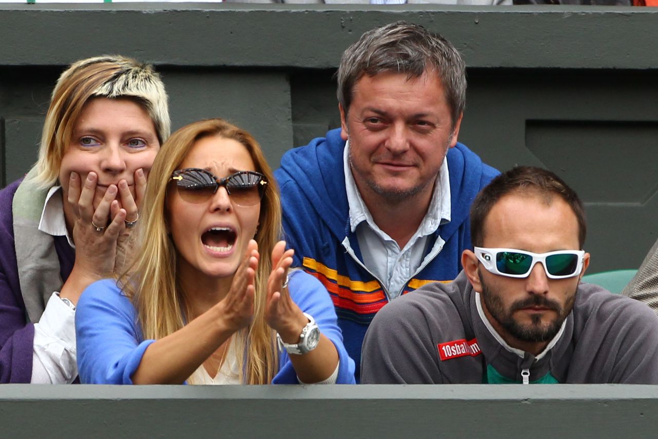 Ristic strikes a typical pose as she supports Djokovic during a match at Wimbledon.
