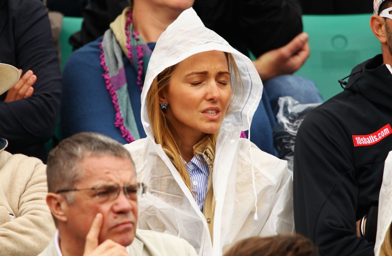 The life of a tennis supporter is not all glamor as a downpour at the French Open leaves Ristic to don protection.