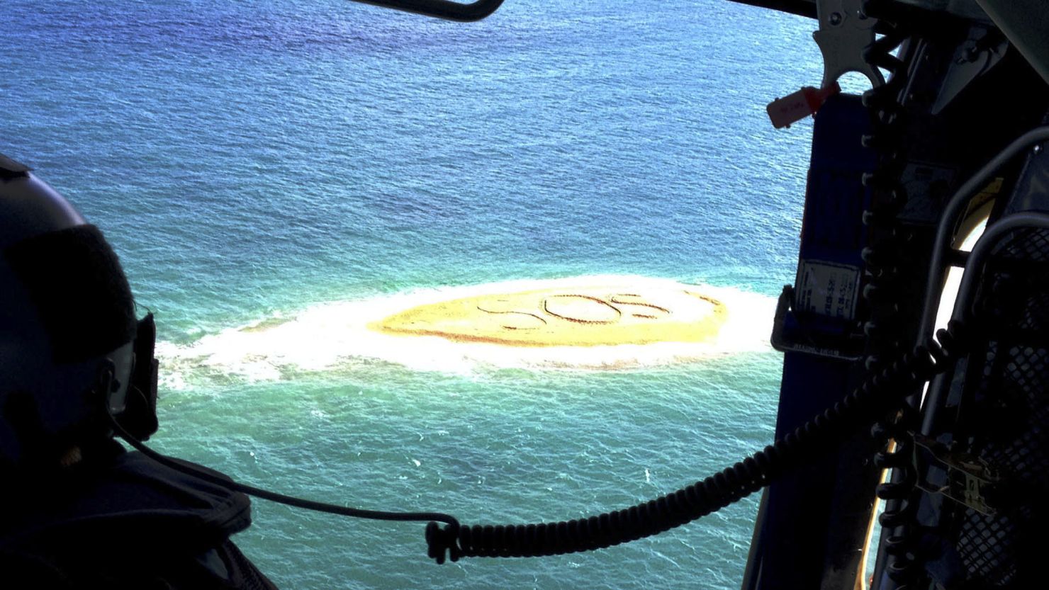 An "SOS" on a sandbar leads Australian searchers to  five snorklers who became stranded when their boat drifted off.