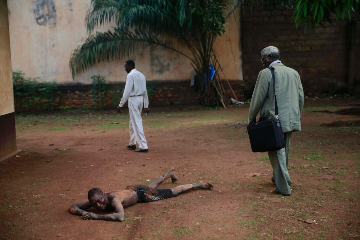 A man accused of being a thief lies in pain after being attacked by a man with a machete and sticks in Bangui, Central African Republic, on Friday, April 18. Foreign journalists intervened and stopped the beating as the crowd shouted "he is a thief, he must die." Police arrived and took the man into custody. He was then taken to a hospital for treatment under police surveillance before being brought before a prosecuting officer.