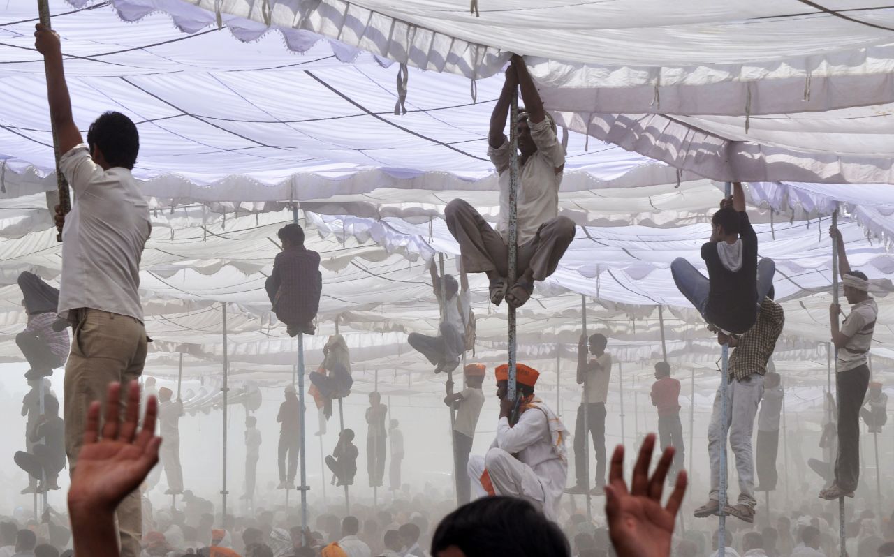 Supporters of Hindu nationalist Narendra Modi, the prime ministerial candidate for India's main opposition Bharatiya Janata Party, climb up the poles of a temporary tent to get a glimpse of Modi during an election campaign rally in Mathura, India, on Tuesday, April 21. It is the <a href="http://www.cnn.com/2014/04/06/opinion/bergen-india-elections-11-things/index.html">largest democratic exercise in history</a> as voters will elect 543 members to the lower house of parliament, which will then select the country's next prime minister. The vote counting will be carried out and concluded on May 16.