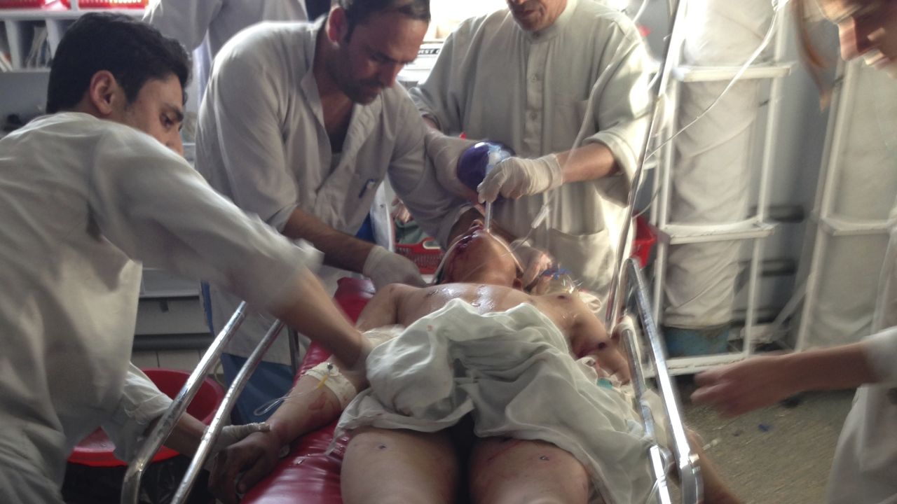 Doctors work to save a young landmine victim.