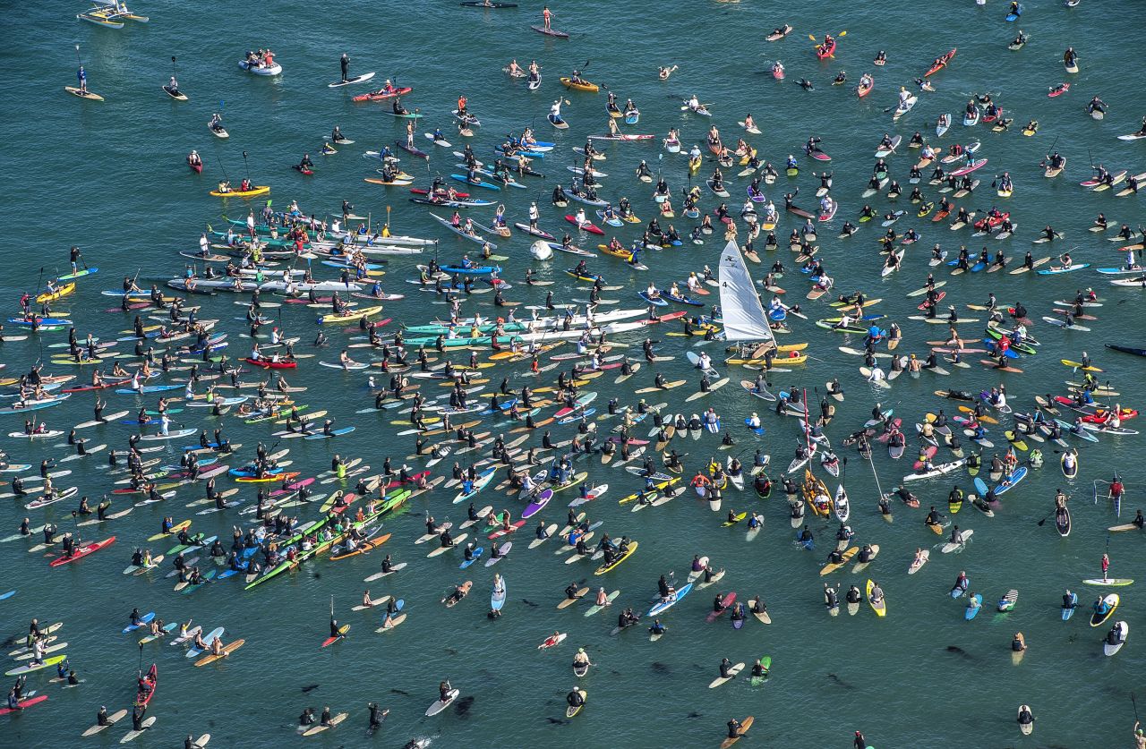 Surfers and rowers gather around a Hobie Cat catamaran off Doheny State Beach in Dana Point, California, on Friday, April 18, to<a href="http://money.cnn.com/2014/01/16/leadership/hobie-surfboards.pr.fortune/"> celebrate the life of surf and sailing entrepreneur Hobie Alter</a>. Hobie died on March 29 at his California home after a lengthy battle with cancer. He was 80.