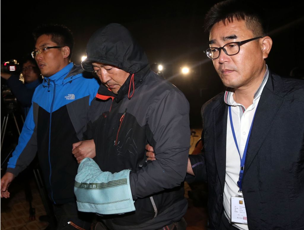 Lee Joon-seok, center, the captain of the <a href="http://www.cnn.com/2014/04/15/asia/gallery/south-korea-sinking-ship/index.html">sunken ferry Sewol</a>, leaves a court that issued his arrest warrant in Mokpo, South Korea, on Saturday, April 19. Lee and some other crew members have been criticized for <a href="http://www.cnn.com/2014/04/23/world/asia/south-korea-ship-sinking/index.html">failing to evacuate the sinking ship quickly</a> and for giving orders for passengers to remain where they were. Lee has said he was worried about the cold water, strong currents and lack of rescue vessels.