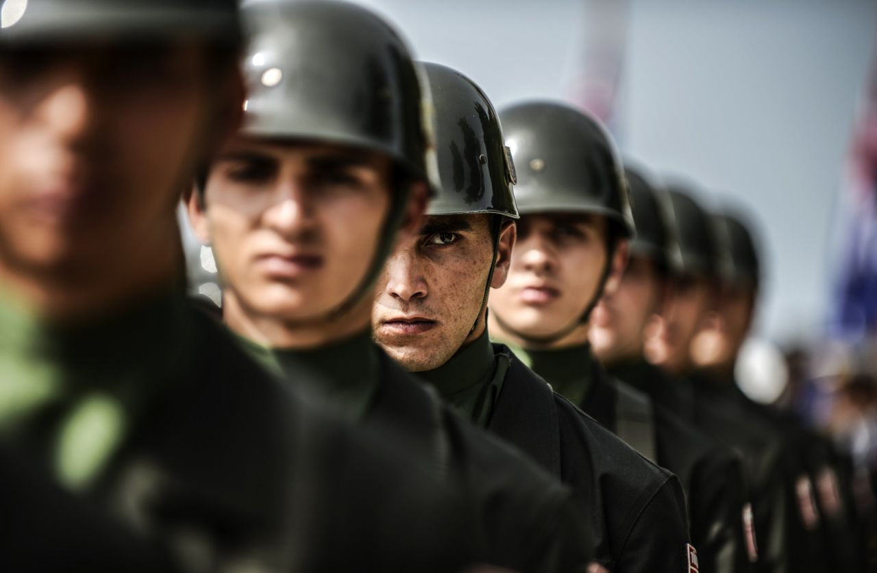 Turkish soldiers stand in line during the ceremony celebrating the 99th anniversary of ANZAC Day in the town of Canakkale, Turkey, on Thursday, April 24. ANZAC is the acronym for Australian and New Zealand Army Corps. The day originally marked the landing of soldiers from both nations at Gallipoli, Turkey, in 1915. In the eight-month campaign fought there, 2,721 New Zealanders and 8,709 Australians died before the allied forces withdrew. The day is now a tribute to those who have died in all conflicts.