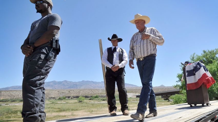 Rancher Cliven Bundy, right, leaves the podium with body guards after a news conference near his ranch in Bunkerville, Nevada, on April 24.  Bundy and the Bureau of Land Management have been locked in a dispute for a couple of decades over grazing rights on public lands.