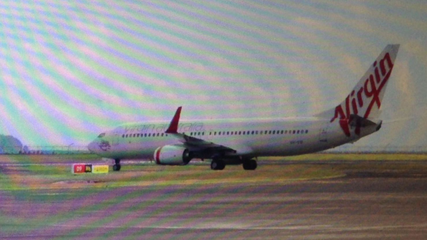 This photo, taken through a plane window, shows the Virgin Australia aircraft at Bali airport, Denpasar on April 25, 2014.