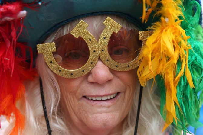 Colorful head pieces are always a feature on race day and, in the case of this punter, hopefully lucky horseshoe sunglasses.