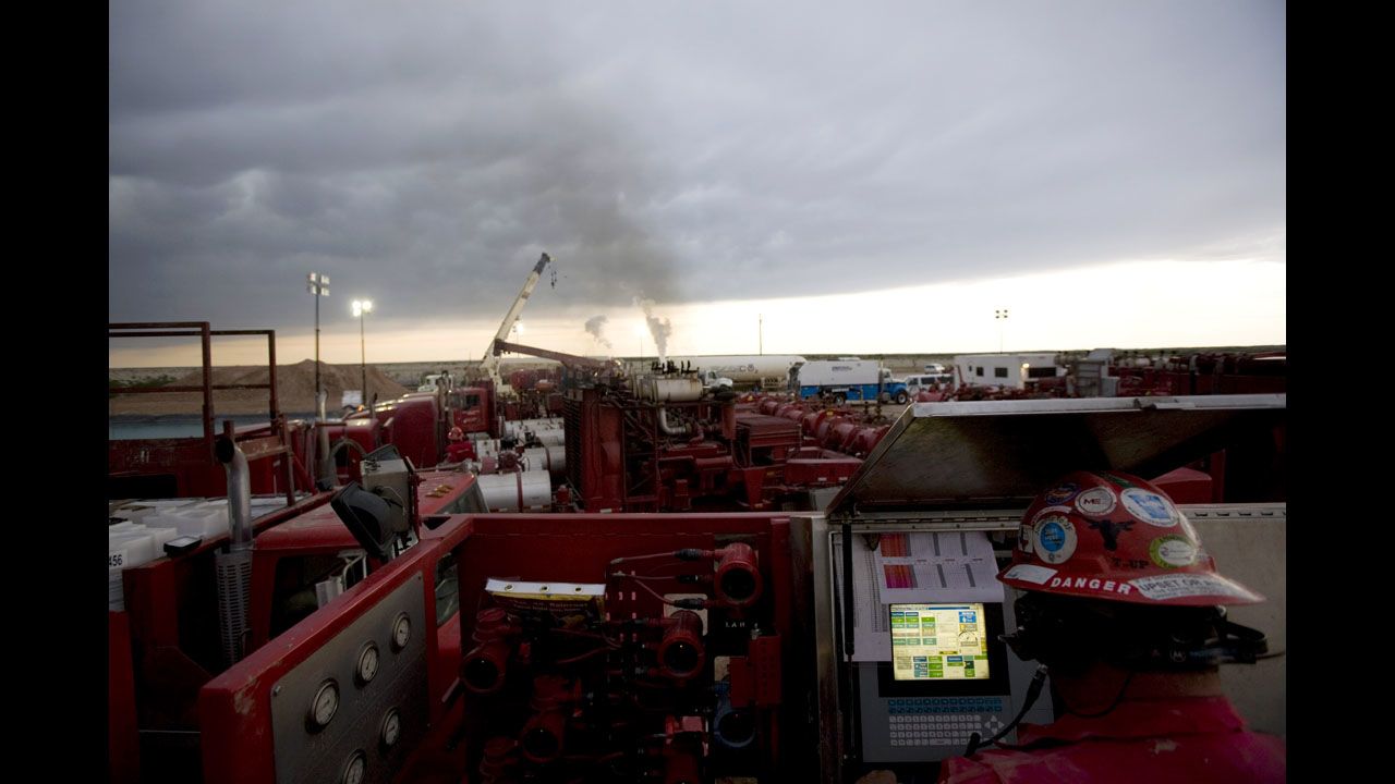 A Halliburton employee monitors a fracking operation outside Hope, New Mexico, in June 2007. Fracking, or hydraulic fracturing, is the process of breaking through dense shale to unlock natural gas.