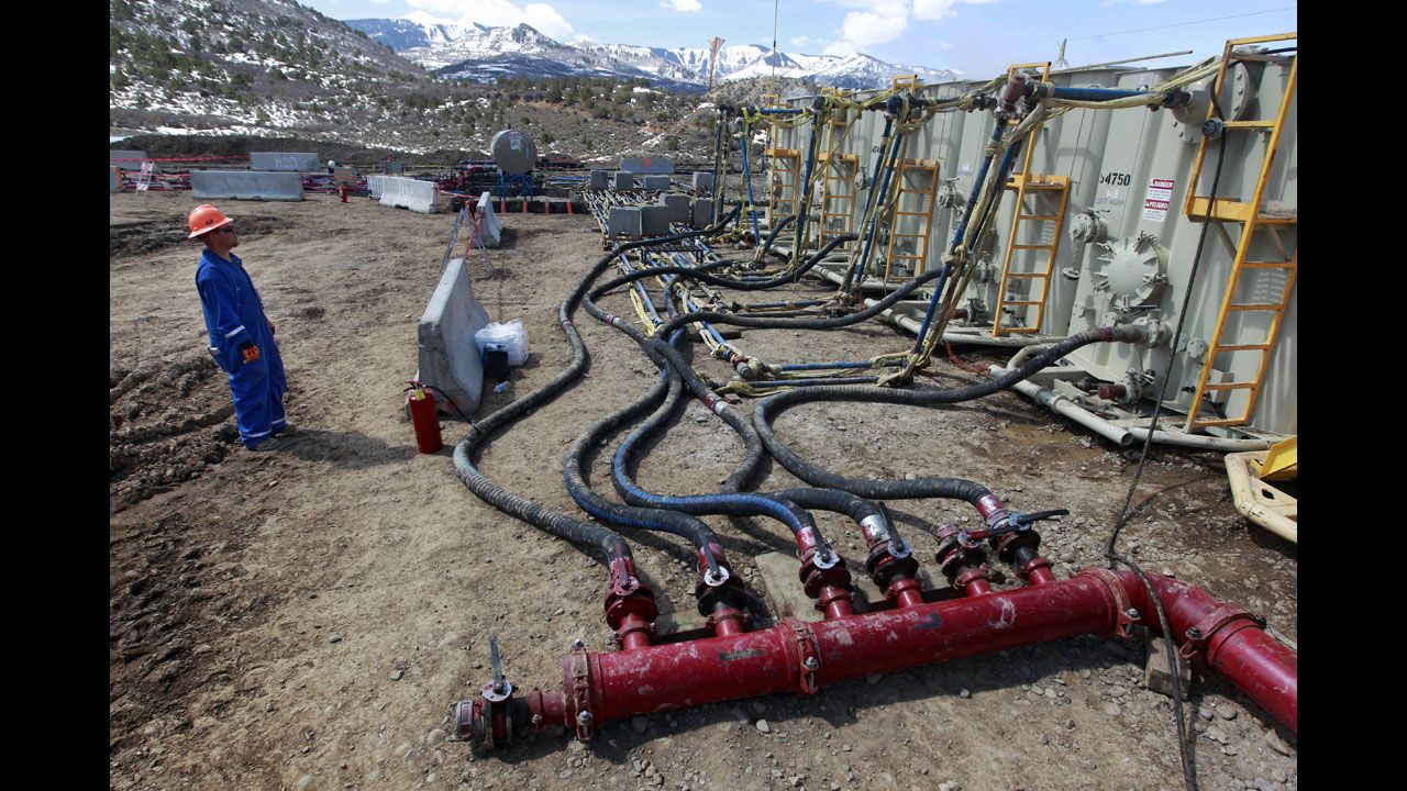 A worker monitors water pumping pressure and temperature at an Encana Oil & Gas fracking site in Rifle, Colorado, in March 2013.