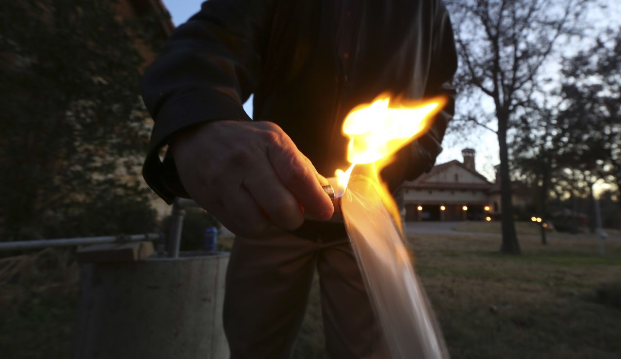 Steve Lipsky lights water flowing from a well spigot on his family's property in Parker County, Texas, near Weatherford, in November 2012. Lipsky says a fracking operation contaminated the well.