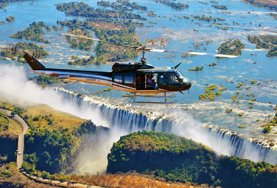 With fully open side doors, the 13-passenger Huey zigzags above the Zambezi River before rapidly rising up and over Victoria Falls.