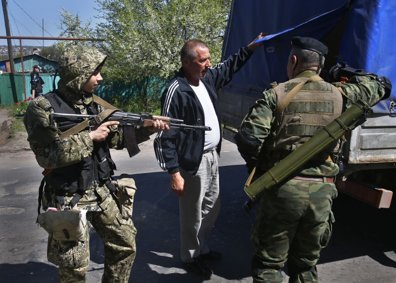 Pro-Russia armed militants inspect a truck near Slovyansk on Friday, April 25. Russian Foreign Minister Sergey Lavrov has accused the West of plotting to control Ukraine, and he said the pro-Russia insurgents in the southeast would lay down their arms only if the Ukrainian government clears out the Maidan protest camp in the capital, Kiev. 
