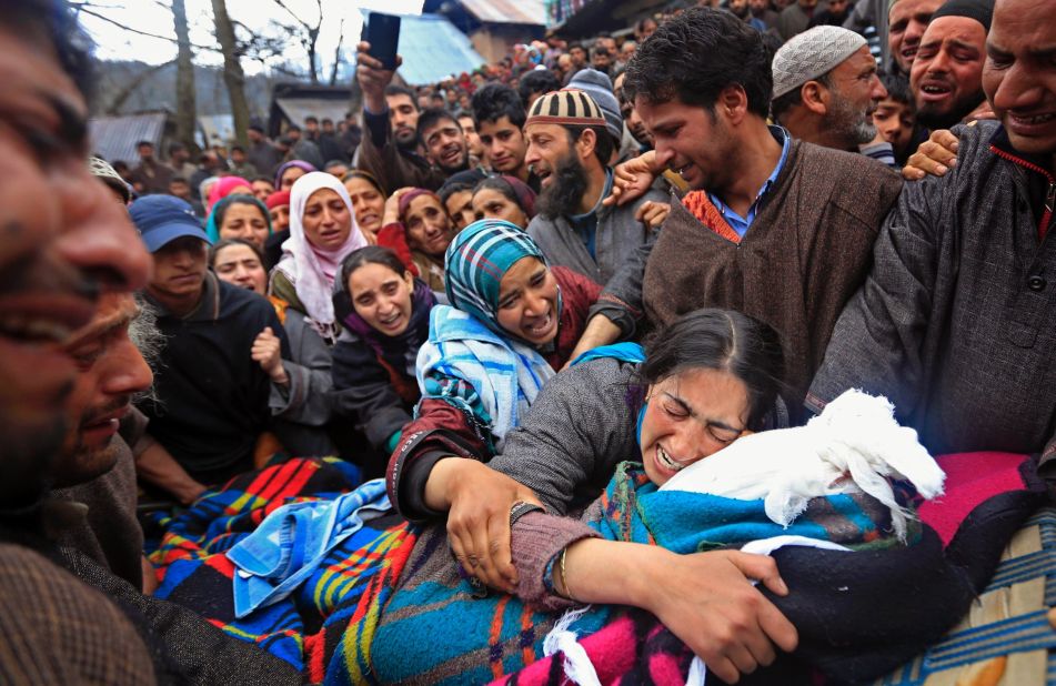 Sumaira Wani, wife of Zia-Ul-Haq, mourns by the body of her husband during his funeral in Hirpora, some 65 kilometers (40 miles) north of Srinagar on Friday, April 25. Zia, an Indian poll official, was killed soon after voting in the ongoing election, when suspected rebels fatally shot him and wounded four others in an attack on a bus in the Indian-controlled portion of Kashmir.