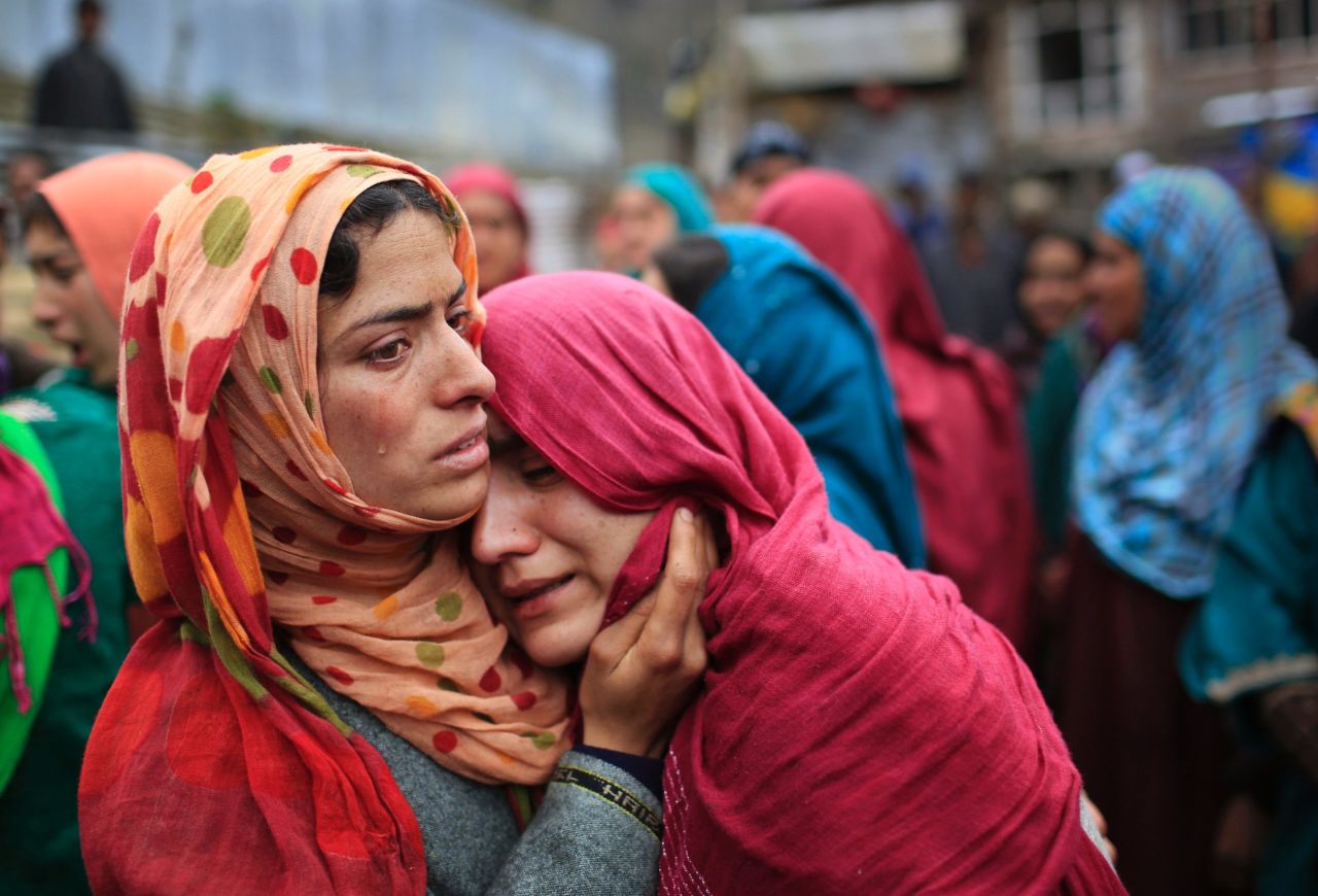 Unidentified relatives cry during the funeral procession of Zia-Ul-Haq in Hirpora on April 25.