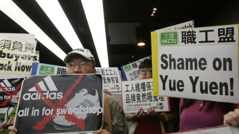 Labor activists protest in front of an Adidas office in a Hong Kong shopping mall.