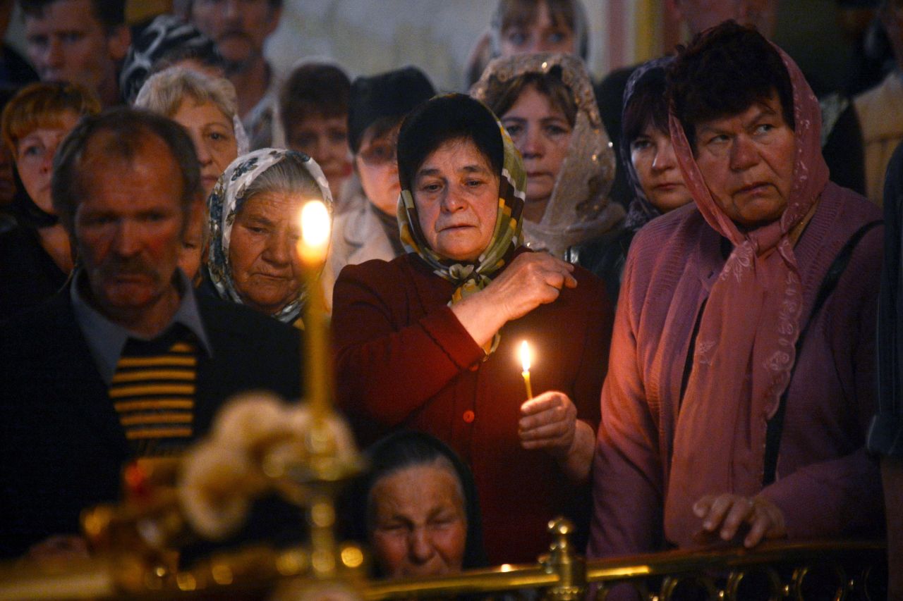 Relatives and friends of a man killed in a gunfight participate in his funeral ceremony in Slovyansk on Saturday, April 26.