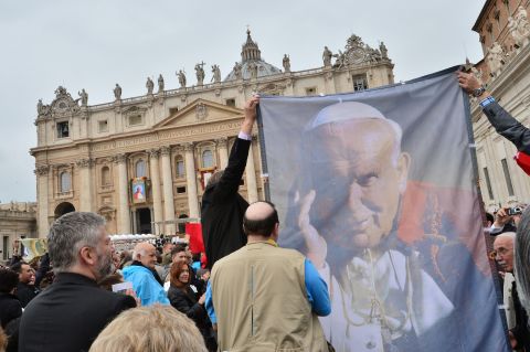 Pilgrims hold up a banner showing Pope John Paul II during the canonization Mass at the Vatican on April 27.