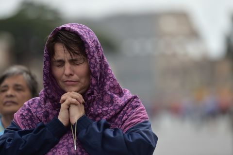 A woman prays during the canonization Mass for Popes John XXIII and John Paul II on April 27.