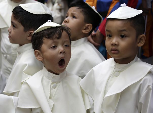 A boy dressed as a pope yawns as he joins a parade in Quezon, Philippines, on April 27 in celebration of the canonization of Pope John Paul II and Pope John XXIII.