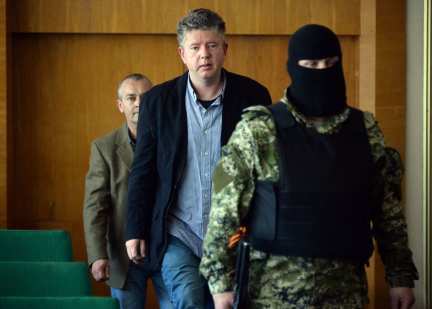 Detained observers from the Organization for Security and Co-operation in Europe arrive to take part in a news conference Sunday, April 27, in Slovyansk. Vyacheslav Ponomarev, the self-declared mayor of Slovyansk, referred to the observers as "prisoners of war."