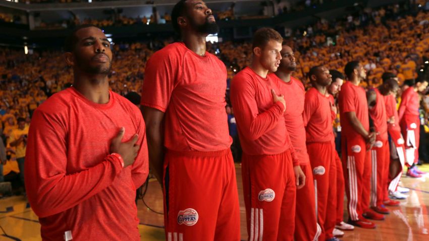 Members of the Los Angeles Clippers wear their red Clippers' shirts inside out to hide the team's logo on April 27.