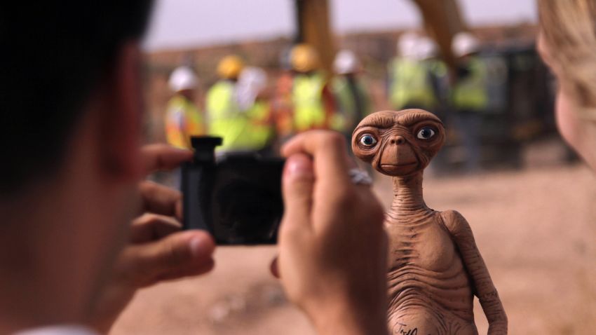 A man takes a photo of an E.T. doll in Alamogordo, New Mexico on Aril 26, 2014.