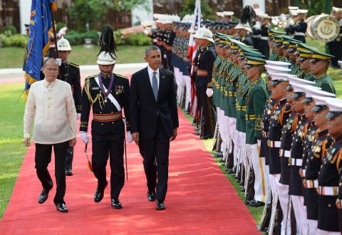 Obama walks with Philippine President Benigno Aquino III as they review an honor guard during a welcoming ceremony at the Malacanang Palace grounds in Manila on Monday, April 28.