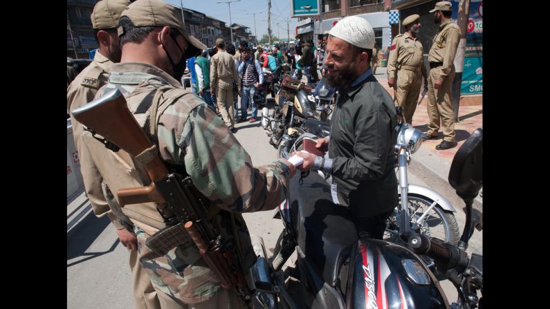 Police conduct a security check Monday, April 28, before voting in Srinagar.