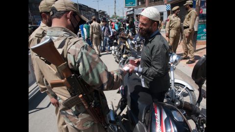 Police conduct a security check Monday, April 28, before voting in Srinagar. 