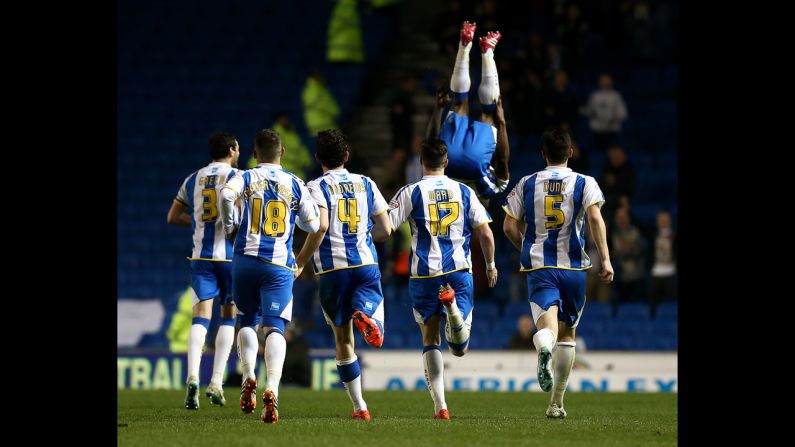 Kazenga Lua Lua flips in the air after scoring a goal for Brighton & Hove Albion during their 2-0 win against Yeovil Town on Friday, April 25, in Brighton, England. The teams play in the Championship, the second-highest division of English soccer.